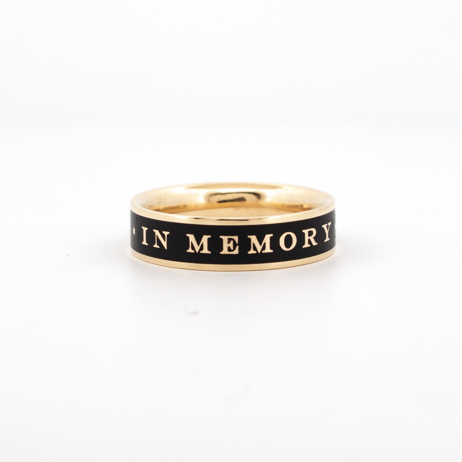 18ct yellow gold memorial ring with black enamel inlay and engraved "IN MEMORY" text.

