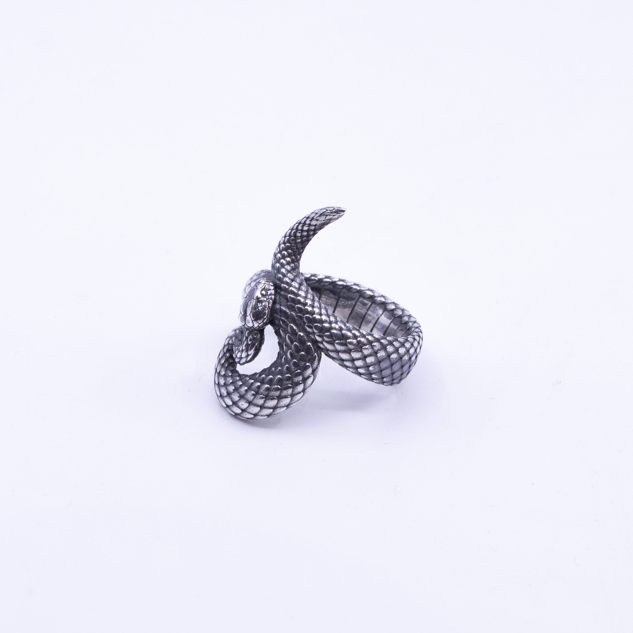 Sterling silver snake ring with detailed scale texture and coiled design, serpent head raised, handcrafted custom jewellery Newtown