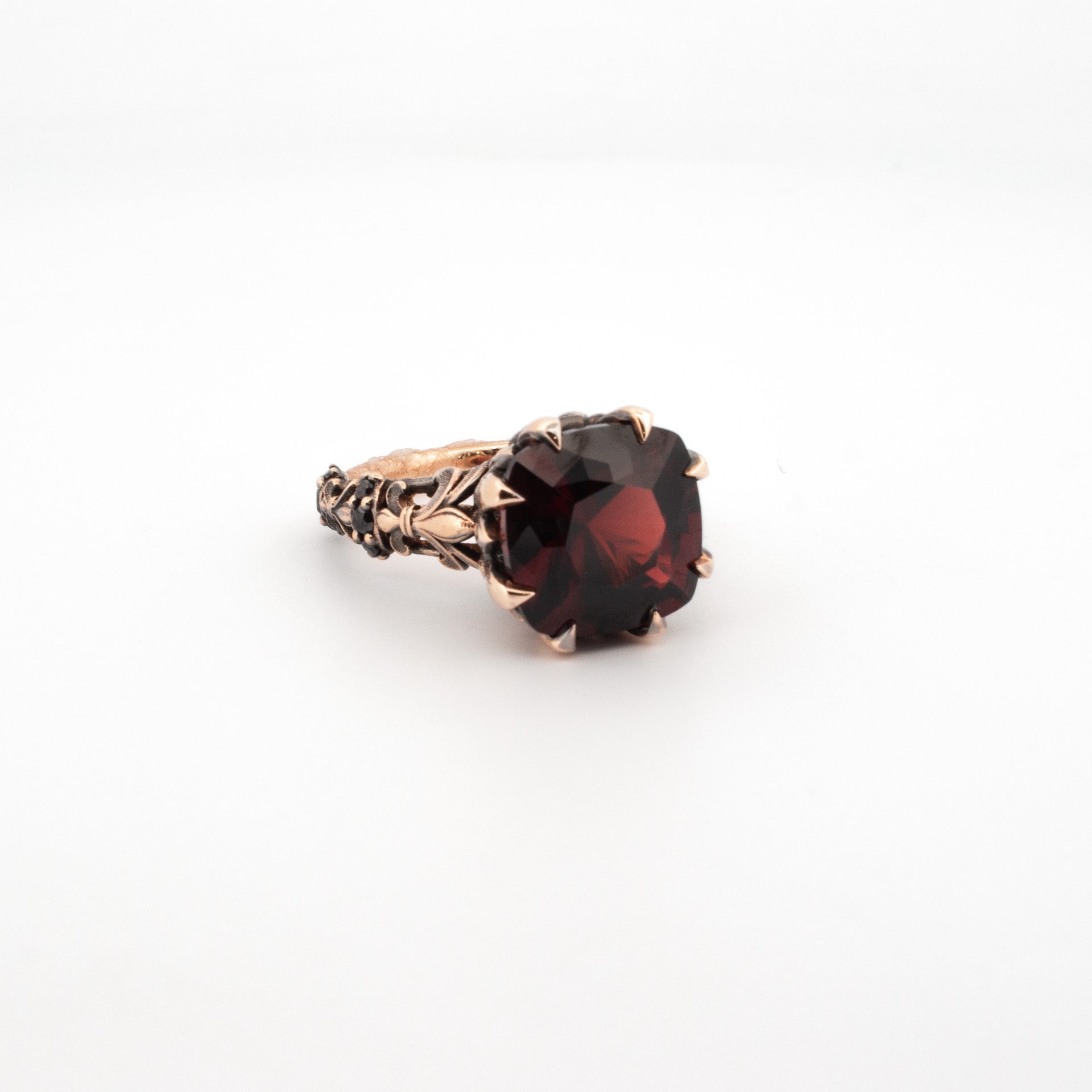 Large garnet ring in rose gold with ornate claw setting and sculpted gothic band, handmade statement jewellery
