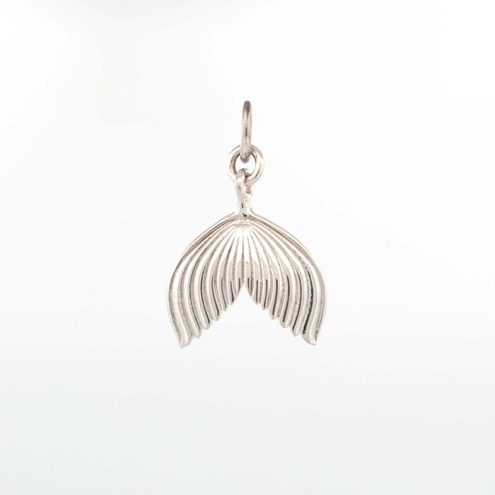 Sterling silver mermaid tail pendant with fine engraved line detailing and polished finish.