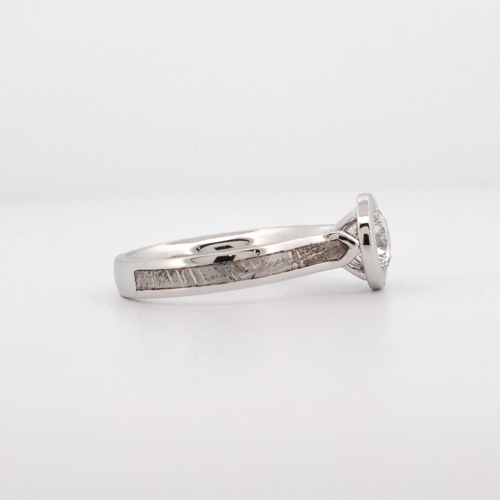 18ct white gold engagement ring with 1.5ct lab grown diamond, bezel setting, and meteorite inlay.