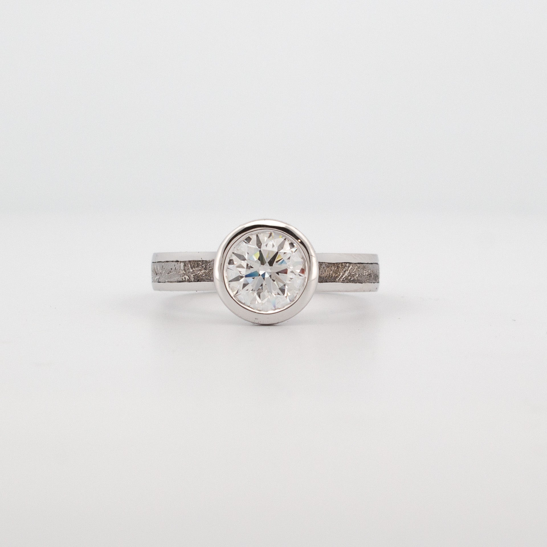 18ct white gold engagement ring with 1.5ct lab grown diamond, bezel setting, and meteorite inlay.
