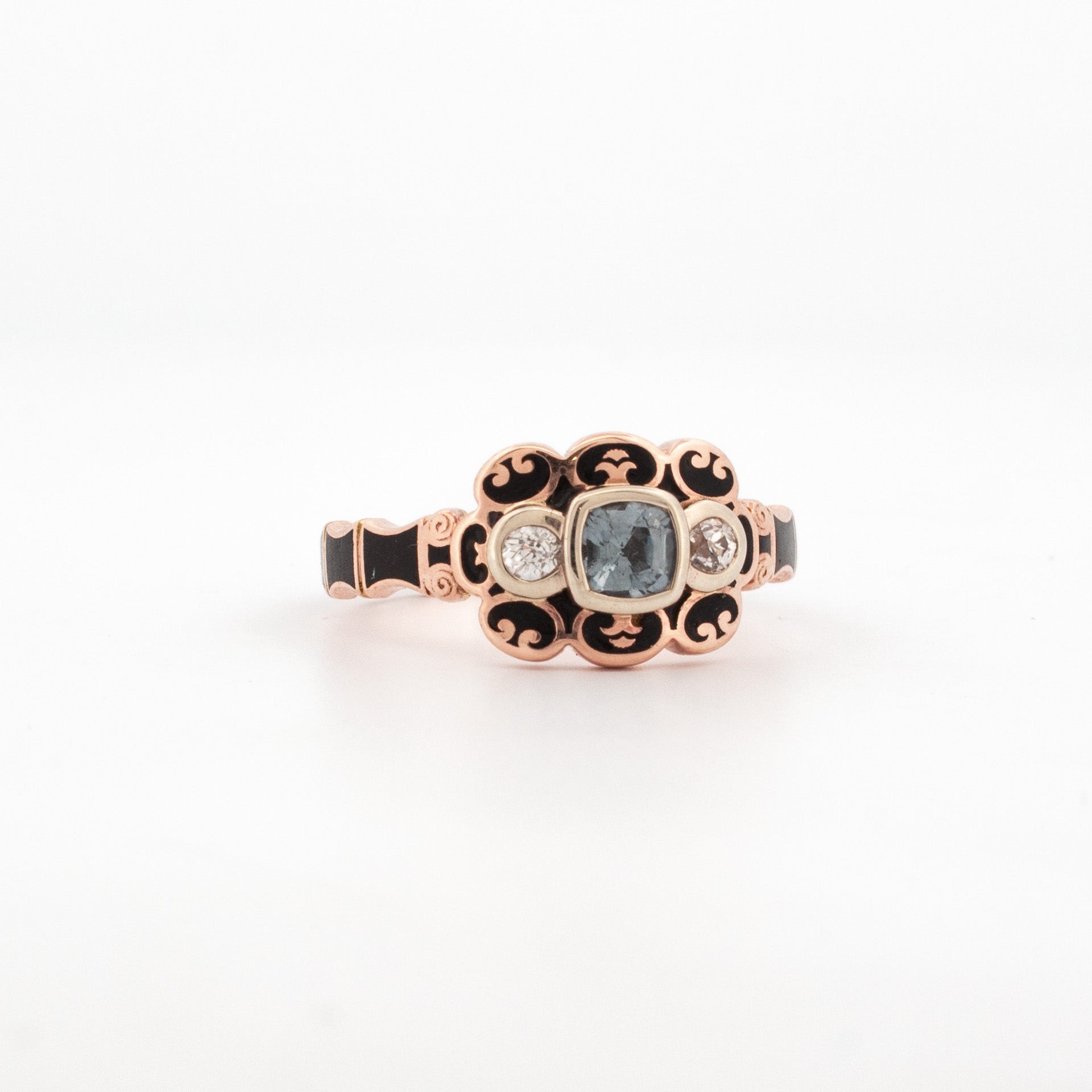 9ct rose gold Victorian mourning style ring with 4.5mm cushion cut grey spinel, rose cut white topaz side stones, and black enamel detailing.