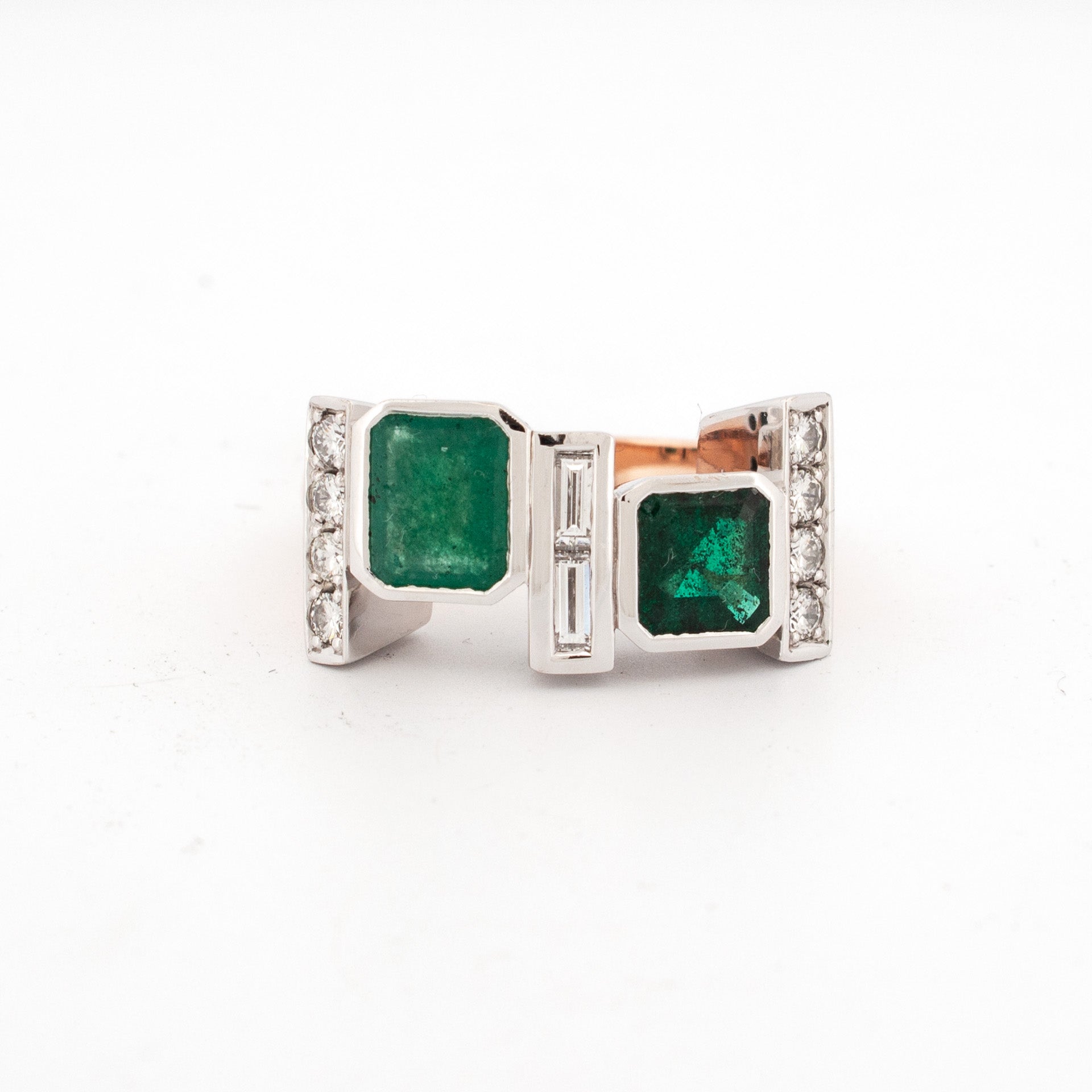 Ring featuring recycled emeralds with baguette and round diamonds in rose and white gold geometric setting.