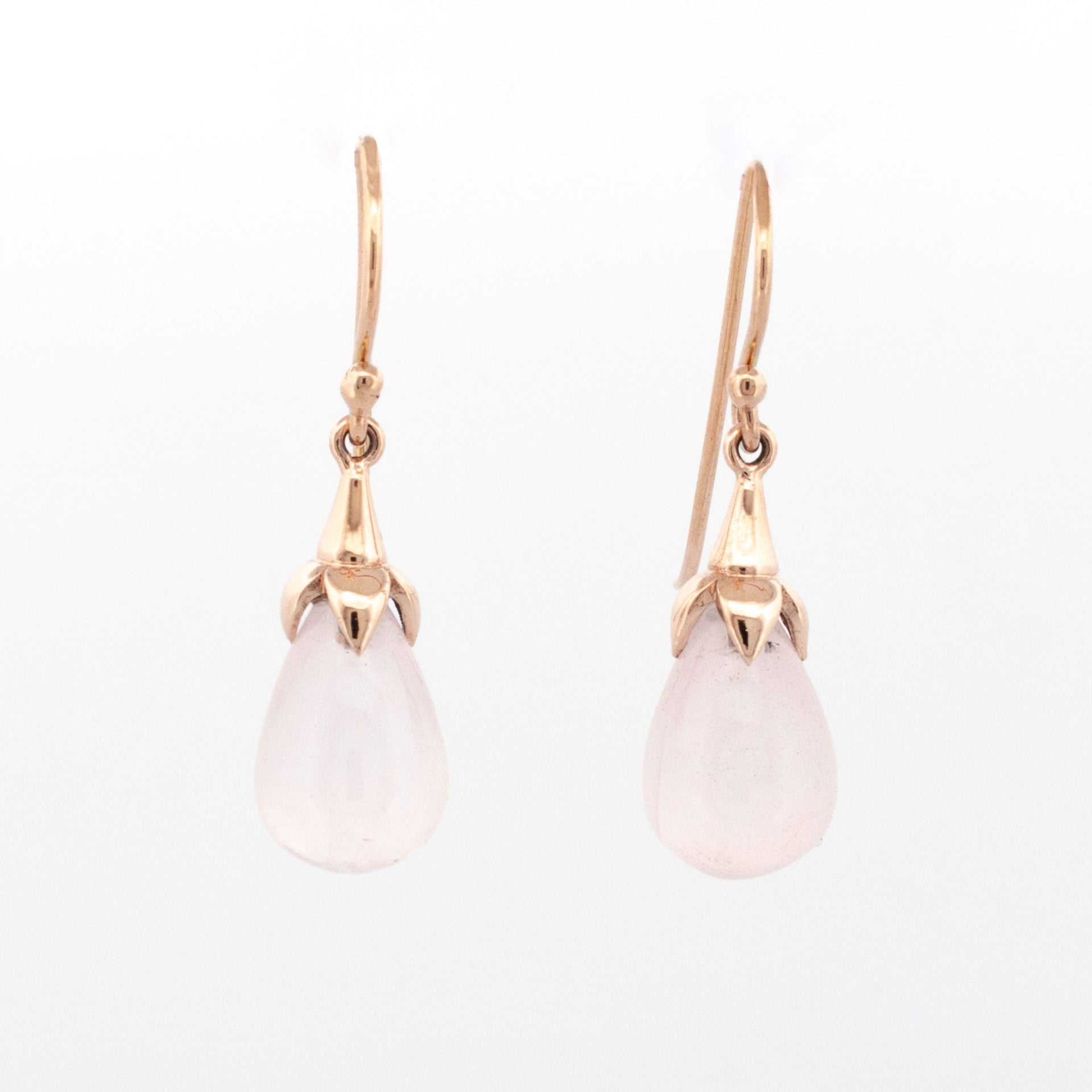 9ct rose gold drop earrings with teardrop-shaped rose quartz cabochons set in petal-style caps and suspended from hook fittings.