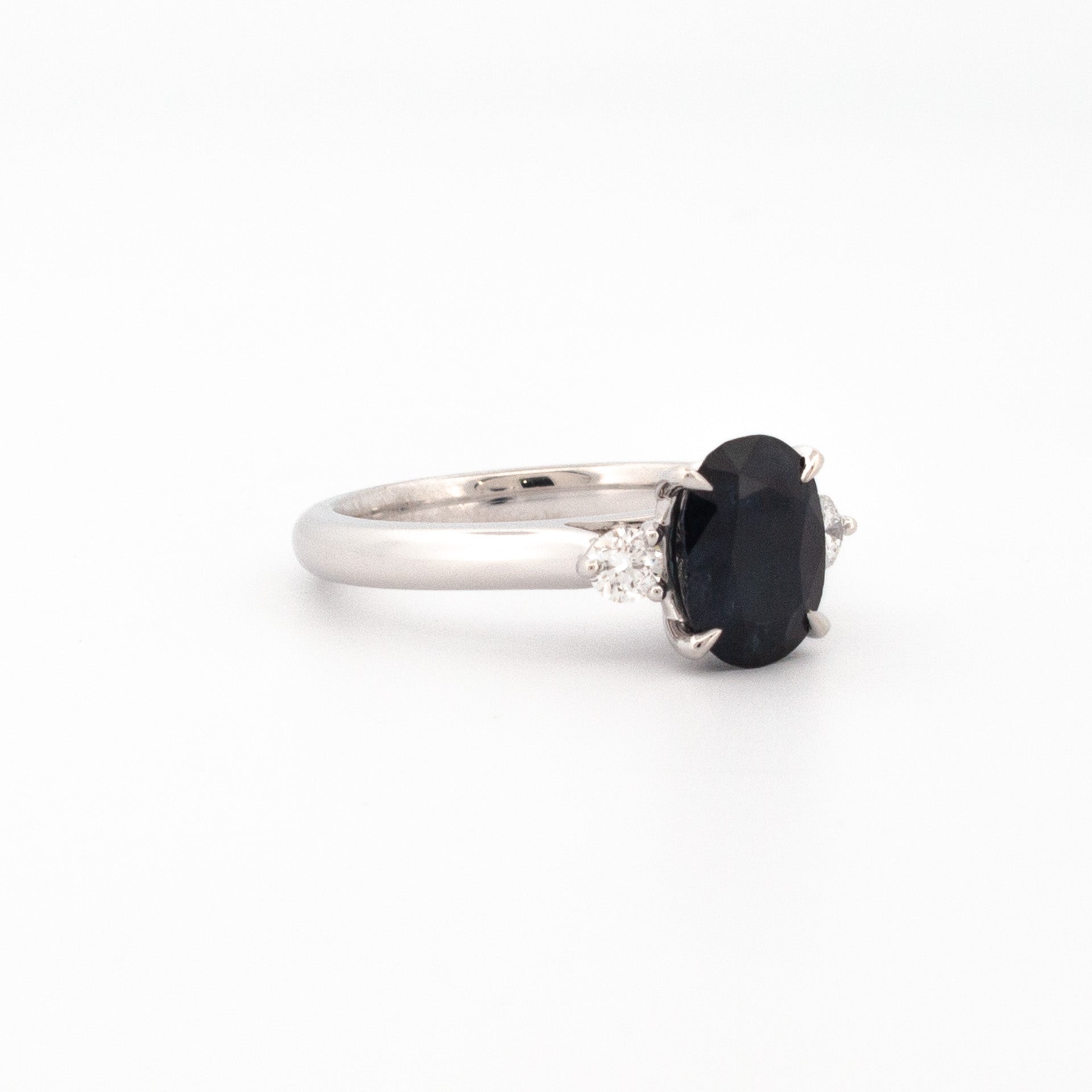 Oval Australian sapphire ring with two round brilliant diamonds set in 18ct white gold claw setting.