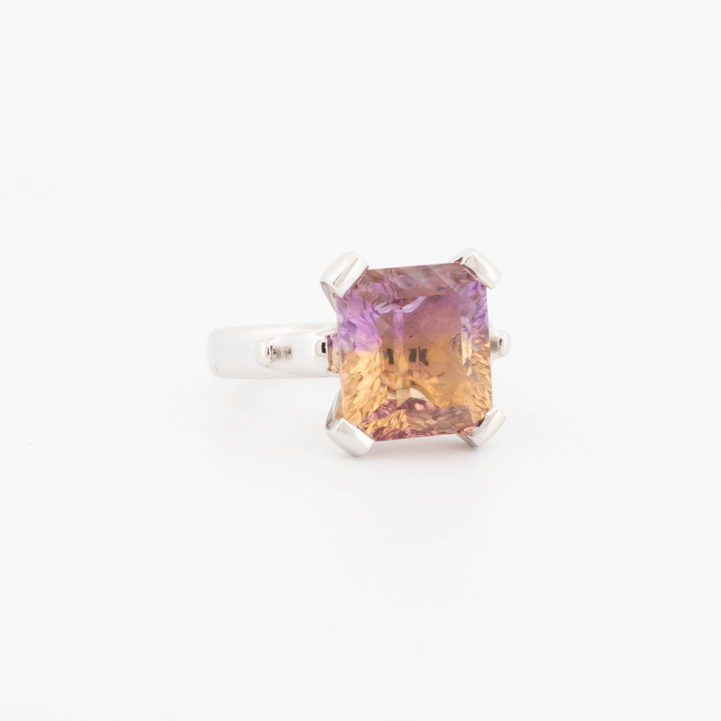 Sterling silver ring with large emerald-cut ametrine gemstone in a four-claw setting, featuring a colour gradient from purple to golden yellow.