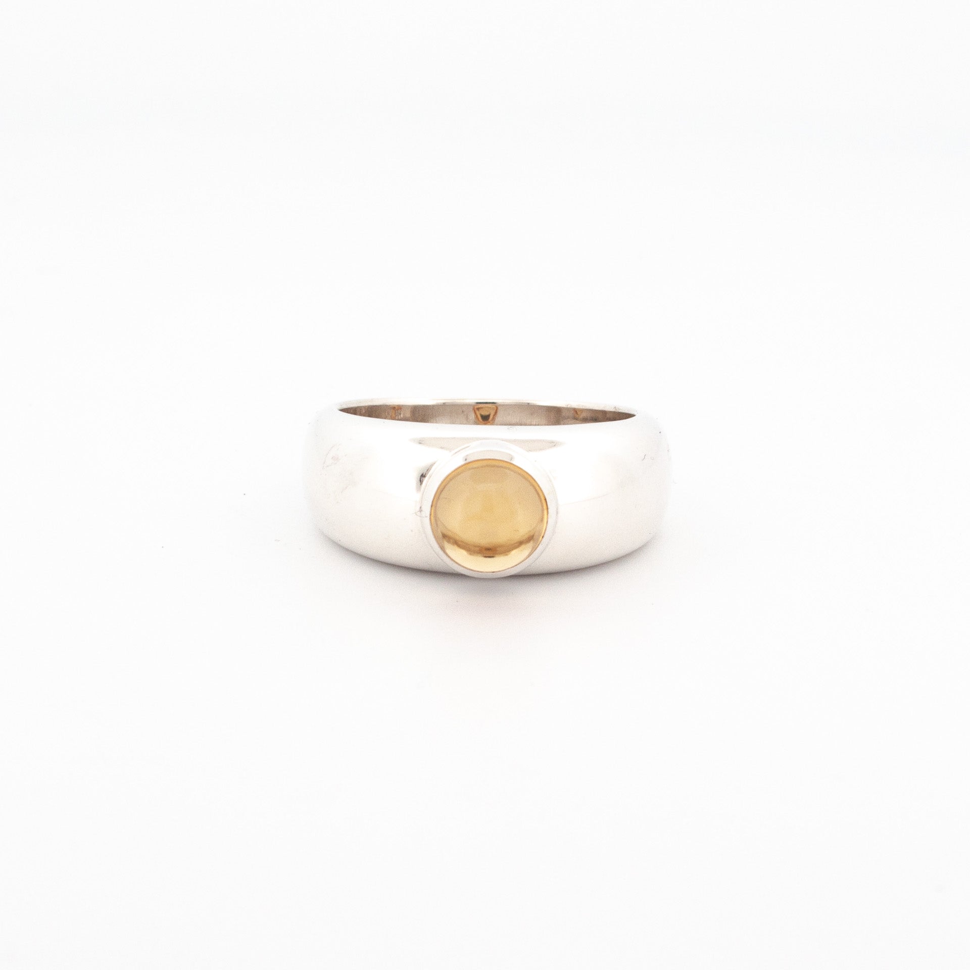 Sterling silver dome ring with a bezel-set 6mm round cabochon citrine gemstone.