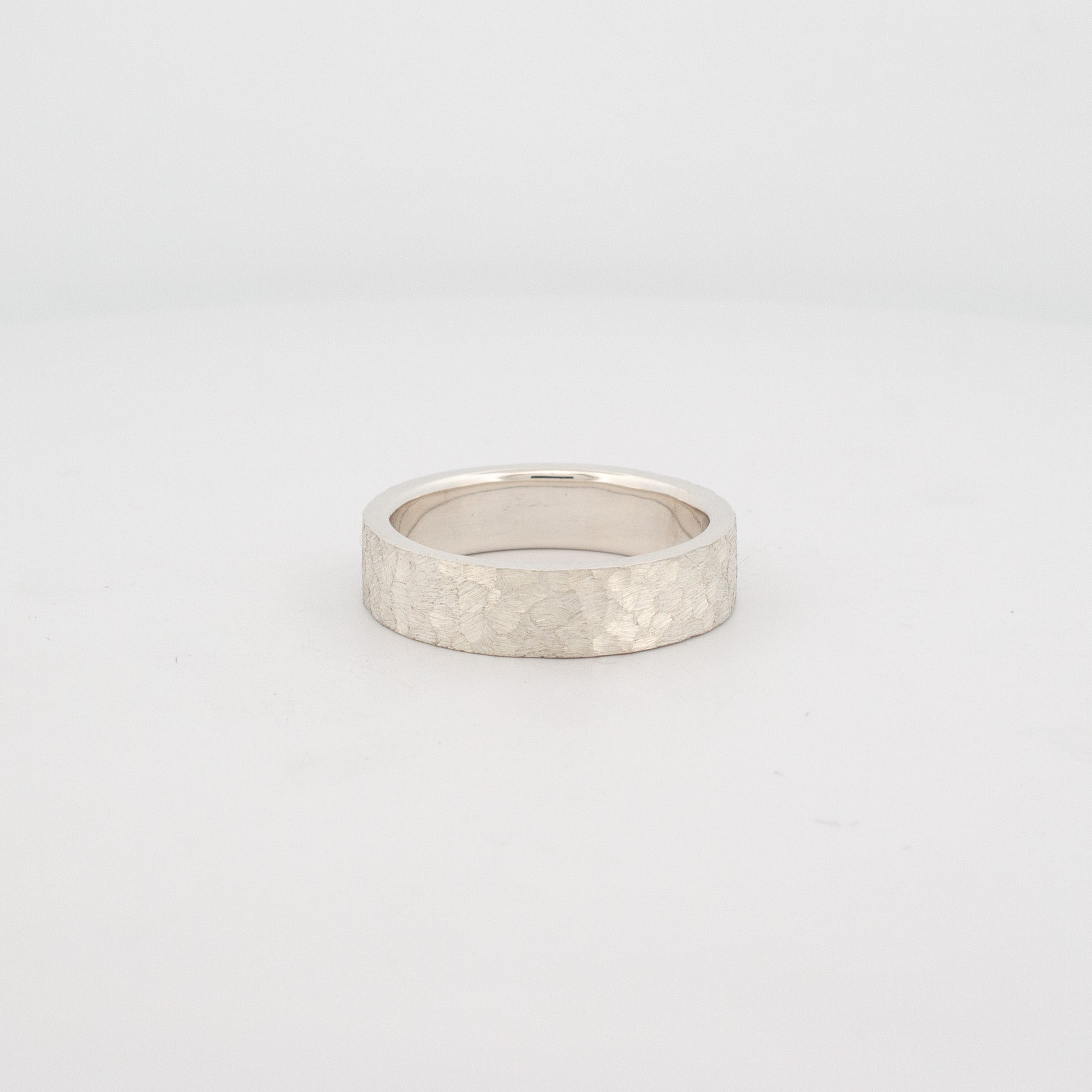 Sterling silver ring with flat profile and textured cobblestone finish, handmade custom men’s or women’s band