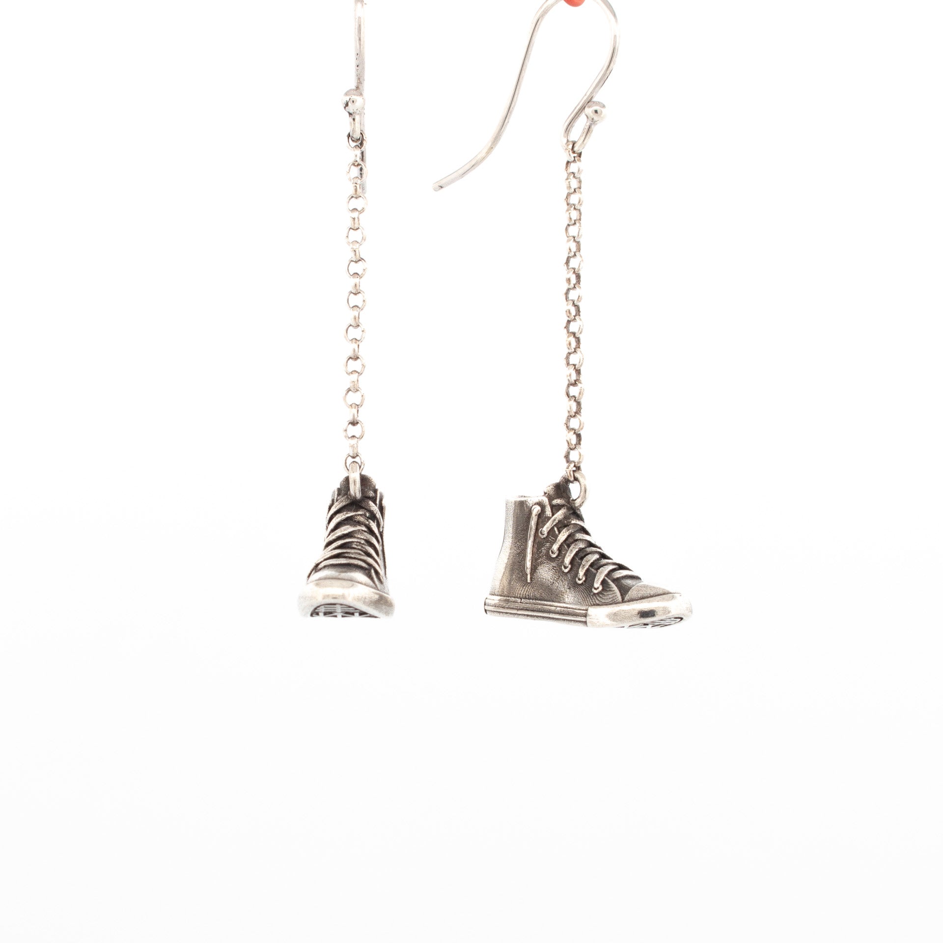Sterling silver high-top sneaker earrings with detailed laces and chain drop hooks.