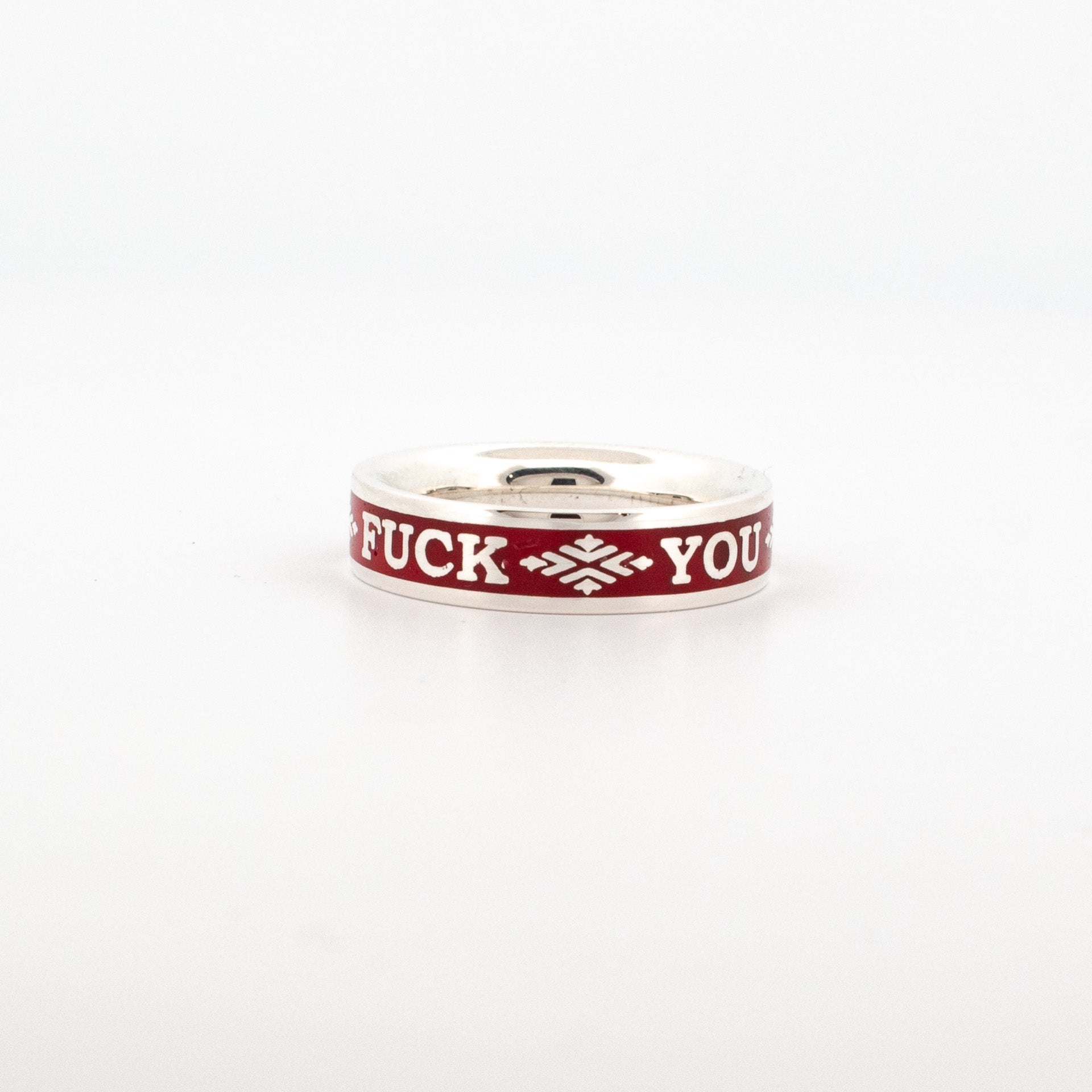 Sterling silver band ring with red enamel inlay, featuring engraved text “F*CK YOU” in white lettering and symmetrical decorative motifs; handcrafted in Newtown, suitable for custom rings or personalised jewellery.