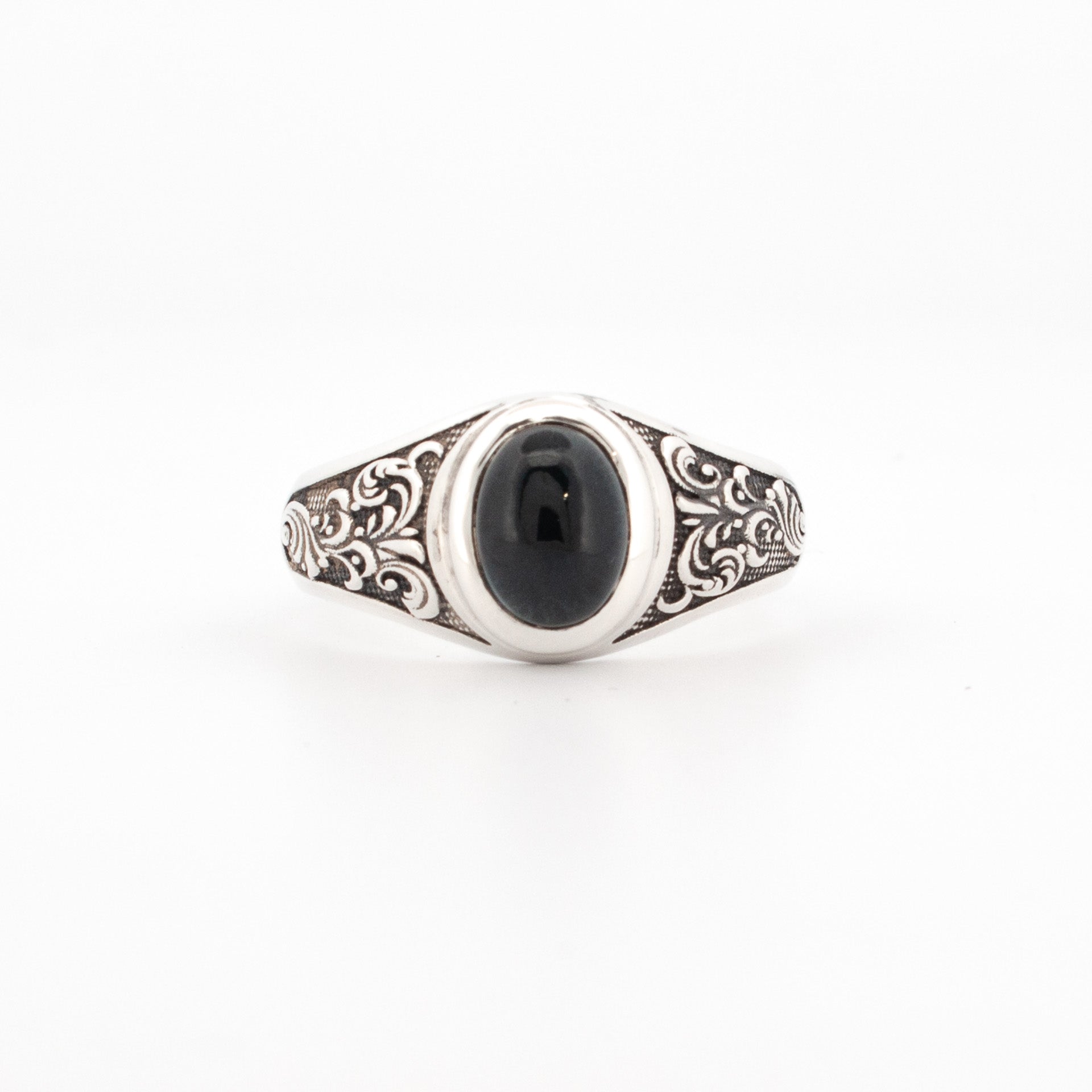 A sterling silver ring featuring an oval London Blue Topaz with engraved shoulder details.