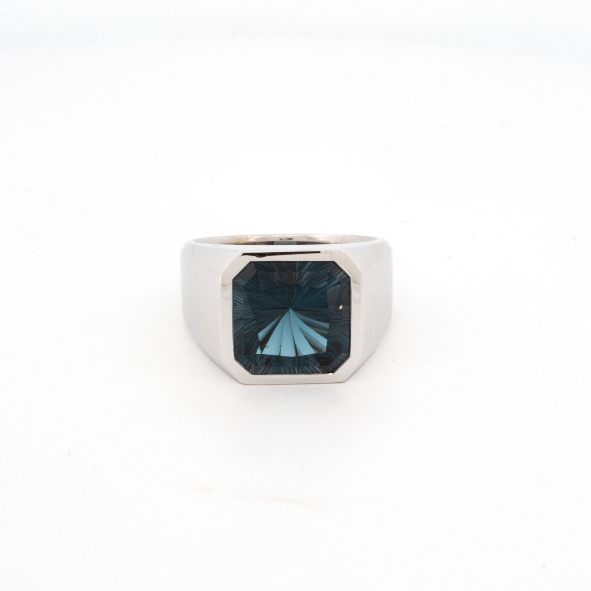 9ct white gold signet ring with octagonal bezel set custom-cut London Blue Topaz featuring concave warp-style faceting