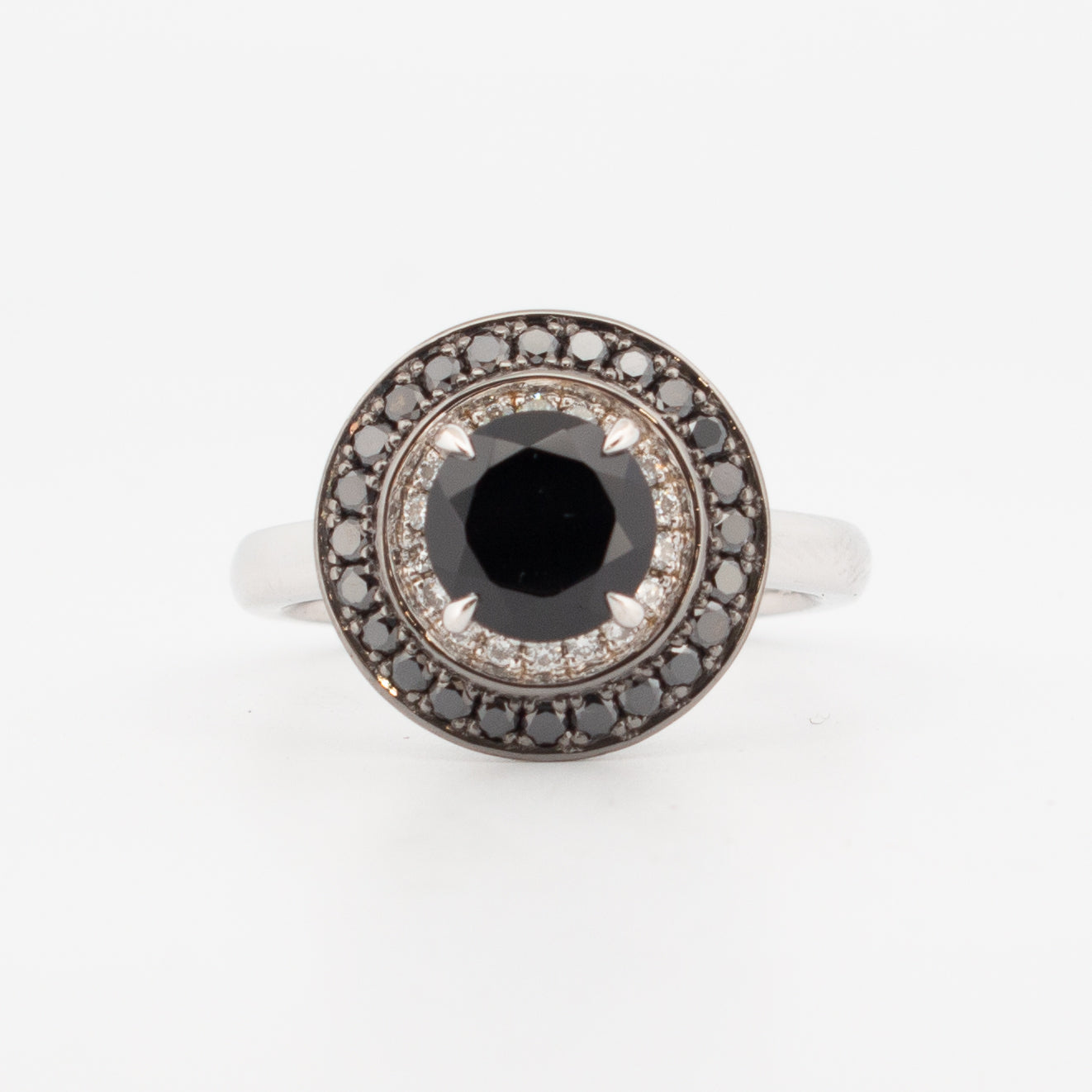 9ct white gold double halo engagement ring featuring a round faceted black spinel centre stone, encircled by pavé-set white and black diamonds with hidden spiderweb detailing beneath the setting."