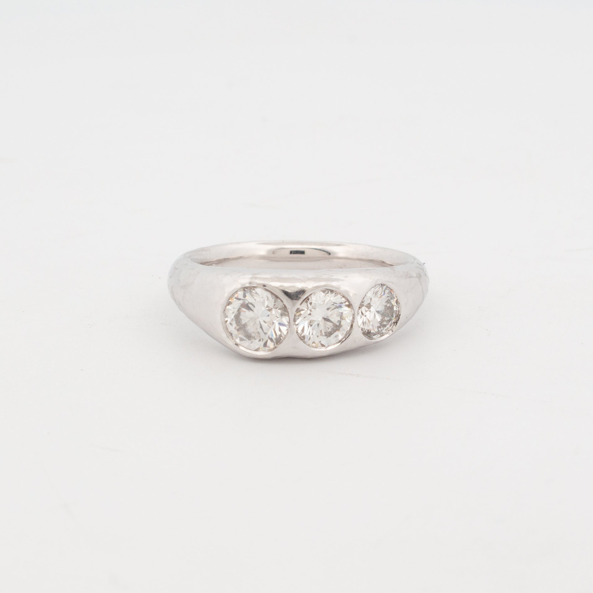 18ct white gold medieval-inspired treasure ring featuring three flush-set natural round brilliant diamonds in a bold, sculptural band. Timeless and weighty design evokes ancient heirloom aesthetics, blending historic craftsmanship with modern fine jewellery elegance.