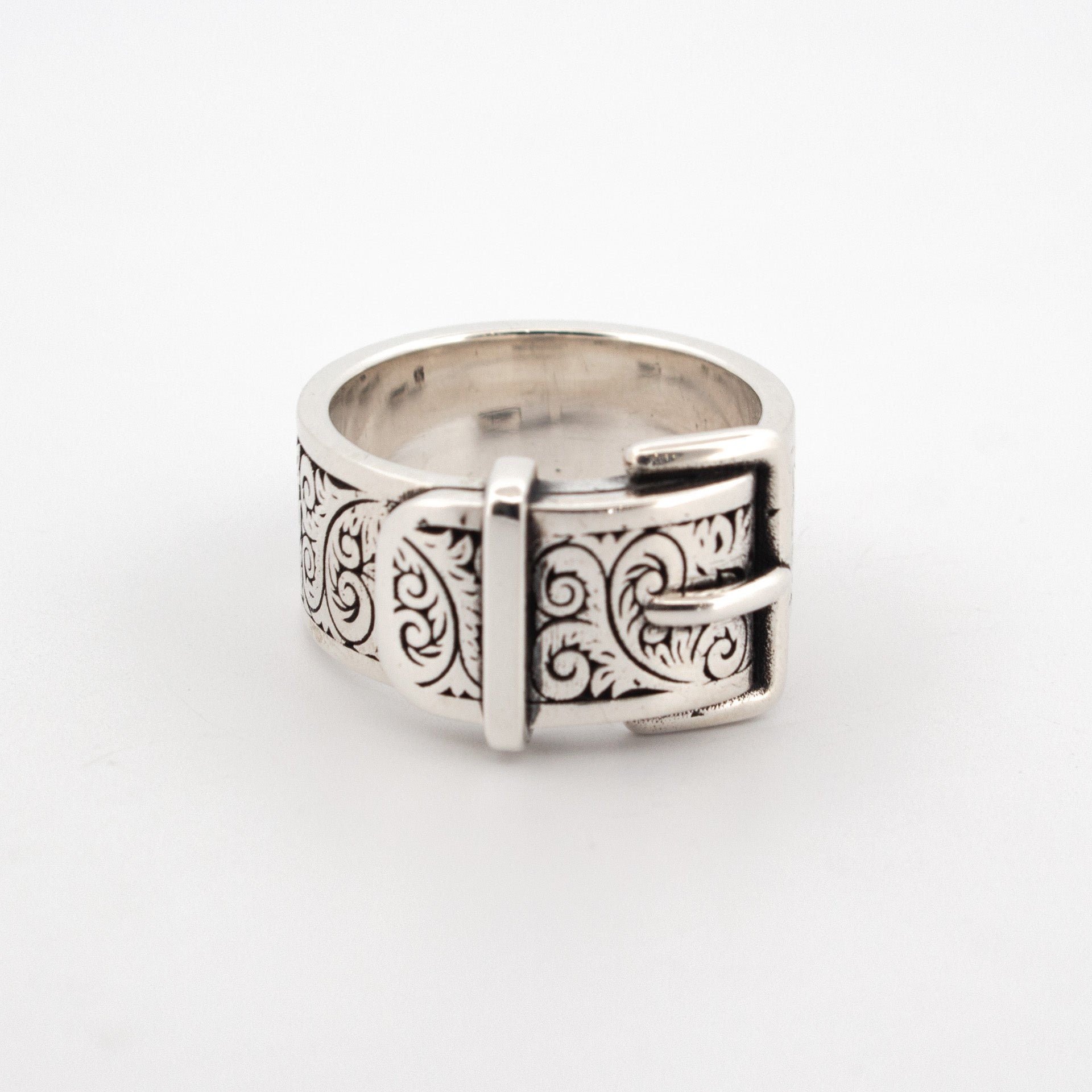 Sterling silver buckle ring with engraved scrollwork pattern and raised buckle detail.
