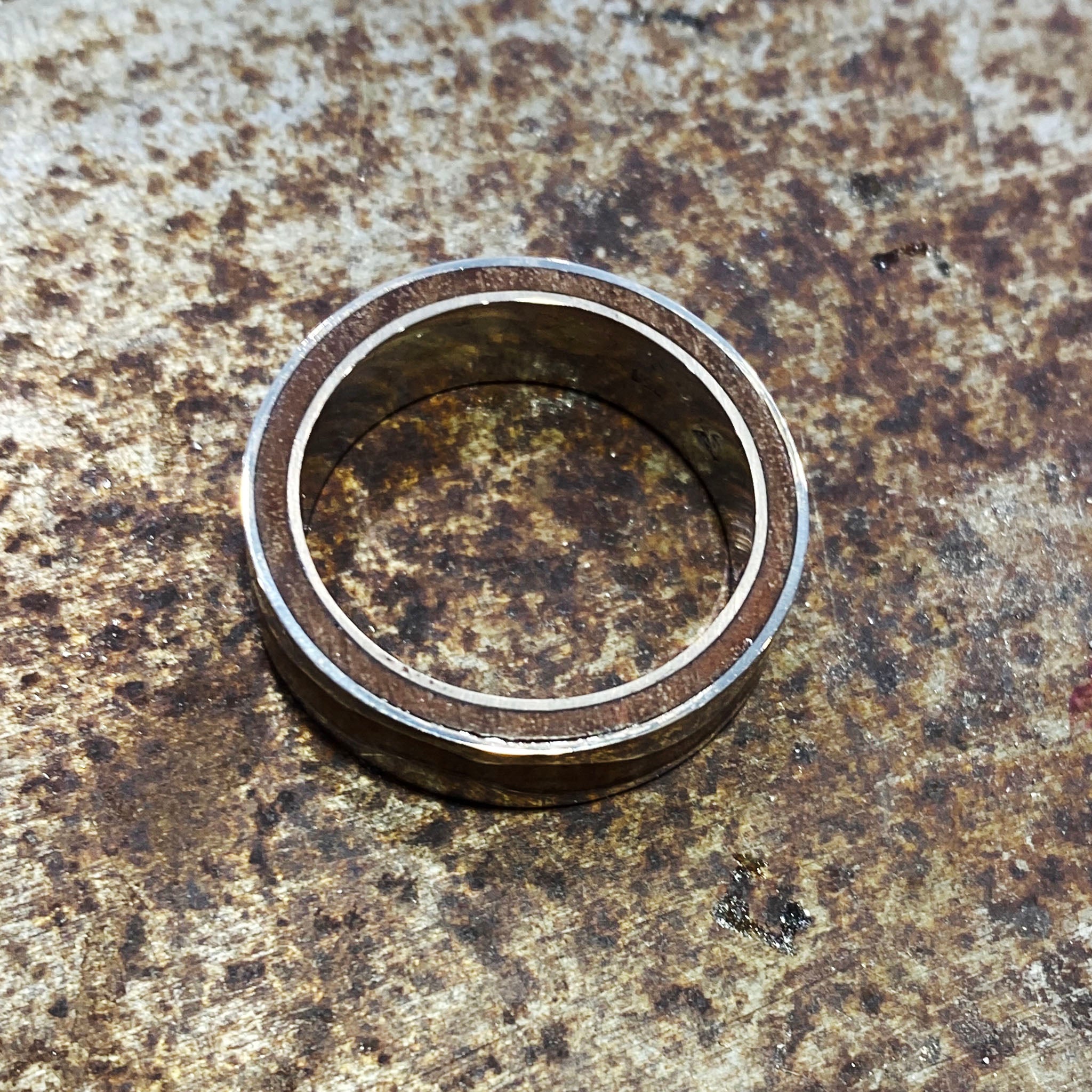 Custom ring with outer sleeve of native Ironbark wood framed by white gold wave pattern, reinforced with inner gold sleeve for strength and durability.