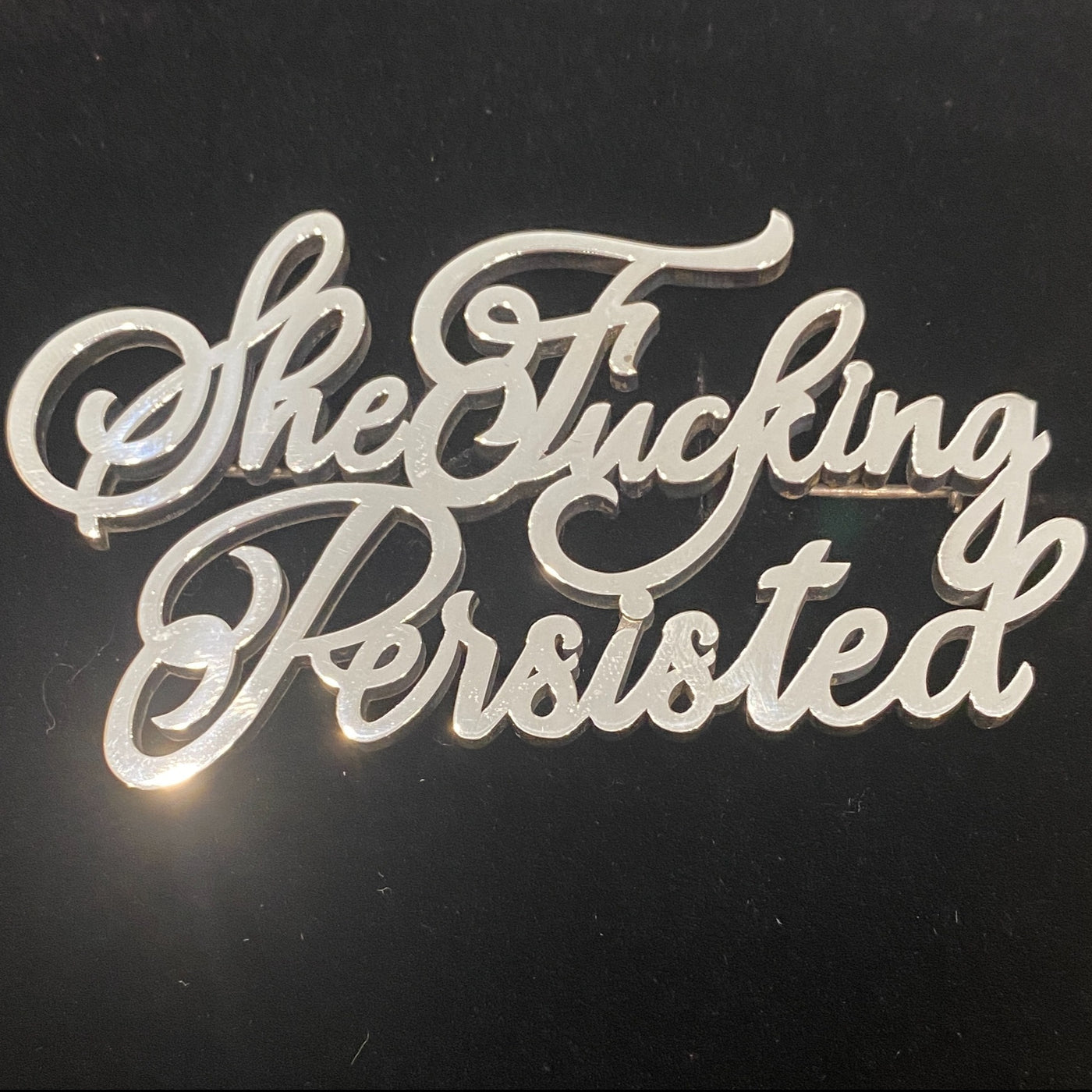 Sterling silver “She Fucking Persisted” statement brooch in cursive script