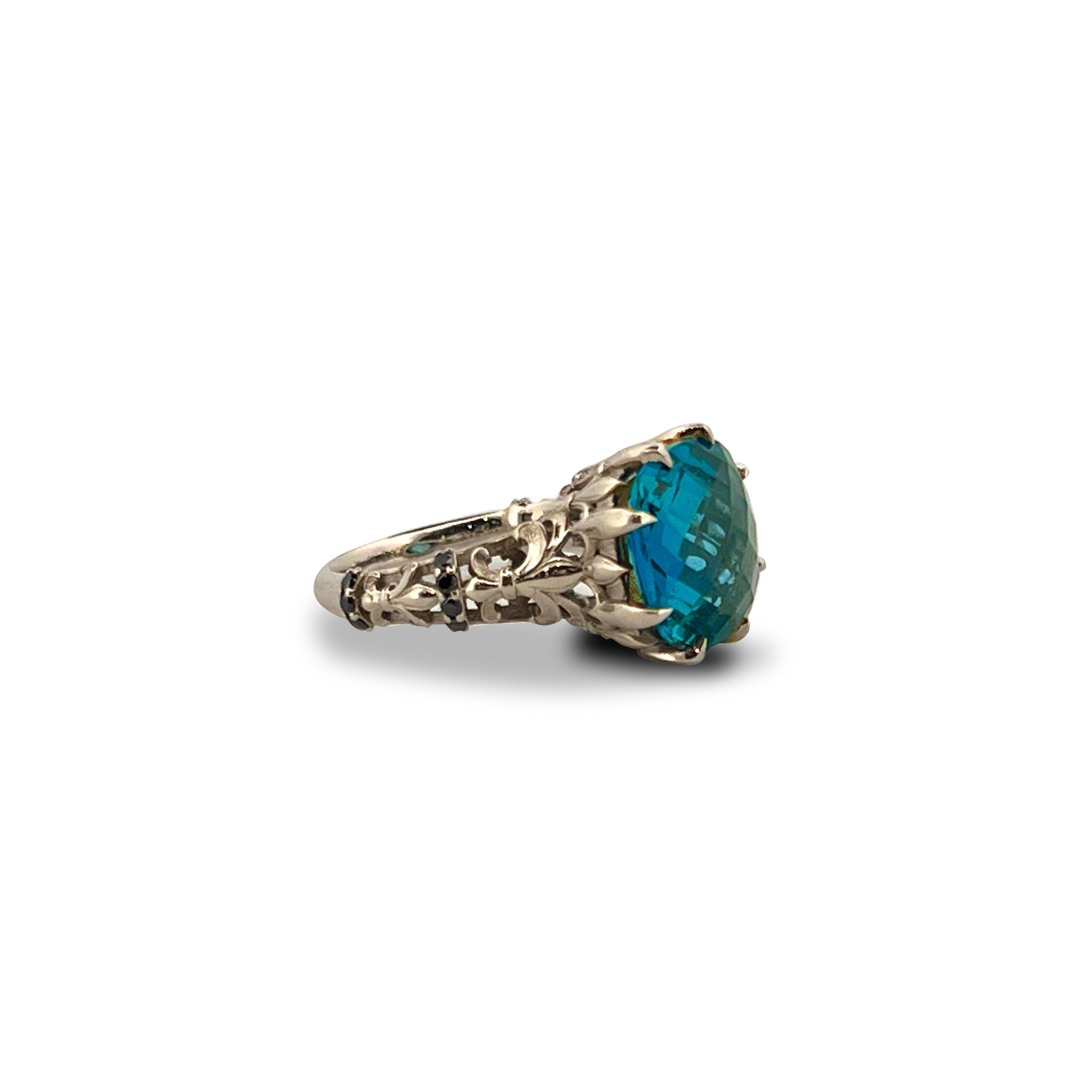 9ct white gold ring with 12mm cushion cut London Blue Topaz checkerboard surface and black diamond accents.